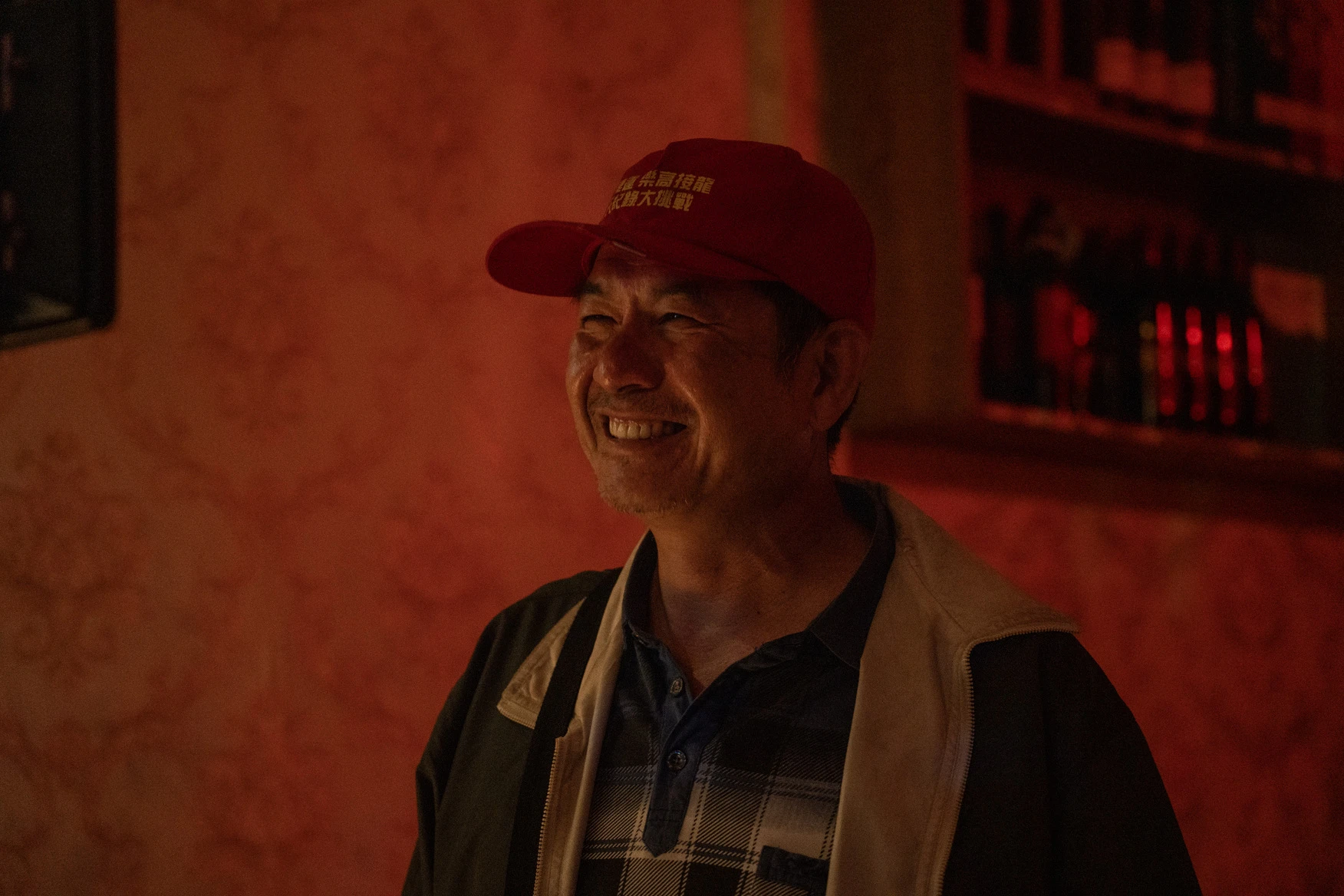 演員洪都拉斯頭戴紅色棒球帽，臉上帶著笑容。
